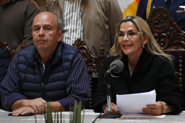 FILE - In this Nov. 23, 2019 file photo, accompanied by Government Minister Arturo Murillo, Bolivia's interim President Jeanine Añez speaks during a press conference at the presidential palace, in La Paz, Bolivia. According to a US Department of Justice statement on Wednesday, May 26, 2021, Murillo has been arrested in the U.S. for allegedly taking part of $602,000 in kickbacks from Florida-based businessmen accused of selling tear gas at inflated prices to the government of former interim President Añez. (AP Photo/Juan Karita, File)