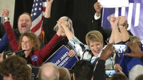 FILE - Supreme Court candidate Janet Protasiewicz, right, holds hands with Wisconsin Supreme Court Justice Rebecca Dallet, left, and Wisconsin Supreme Court Justice Ann Walsh Bradley, blocked from view at far right, at a watch party in Milwaukee, on April 4, 2023. The Wisconsin's Supreme Court flips from majority conservative to liberal control on Aug. 1 when Protasiewicz is set to be sworn in. (Mike De Sisti/Milwaukee Journal-Sentinel via AP, File)