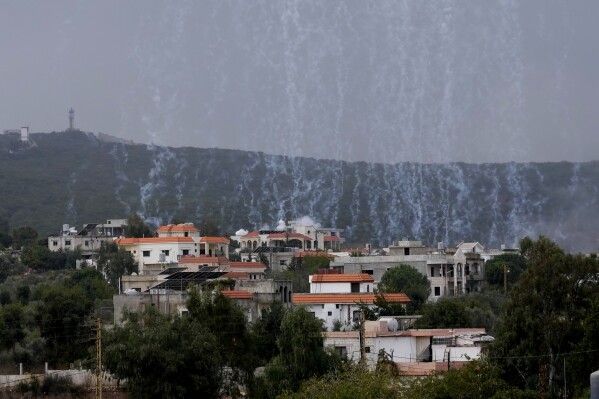 A shell from Israeli artillery explodes over Aita al-Shaab a Lebanese border village with Israel, south Lebanon, Sunday, Oct. 15, 2023. Shelling and clashes near the Lebanese southern border village of Aita al-Shaab and northern Israeli border town of Shtula marks an ongoing escalation in clashes between Hezbollah and the Israeli military. (AP Photo/Hussein Malla)