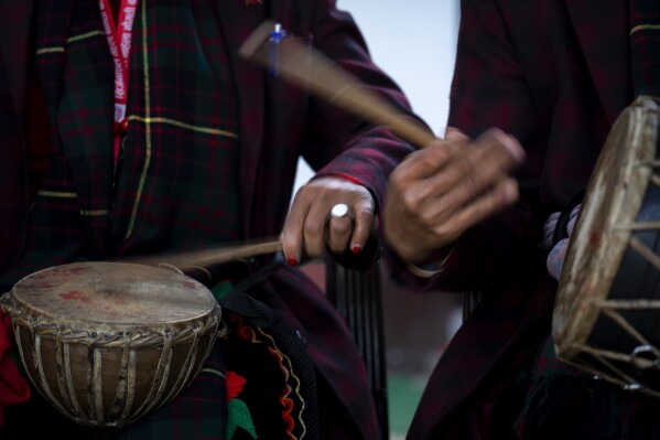 Members of Shrijanshil Mahila Sanstha, or the Self-Reliant Women’s Group, play traditional musical instruments at a wedding in Kathmandu, Nepal, Wednesday, March 6, 2024. (AP Photo/Niranjan Shrestha)