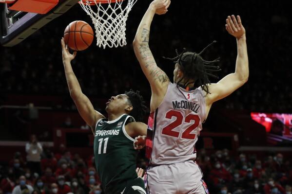 Michigan State guard A.J. Hoggard (11) drives to the basket against Rutgers guard Caleb McConnell (22) during the first half of an NCAA college basketball game in Piscataway, N.J., Saturday, Feb. 5, 2022. (AP Photo/Noah K. Murray)