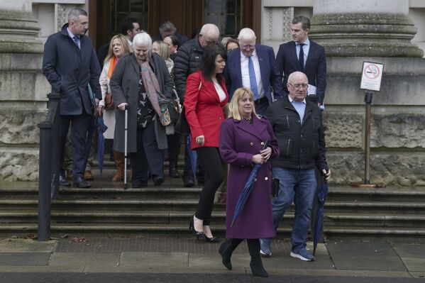 Families and supporters leave Belfast High Court after a High Court judge ruled that one of the key elements in the UK government's Troubles Act is unlawful, in Belfast, Northern Ireland, Wednesday, Feb. 28, 2024. A new law that gives immunity from prosecution for most offenses committed during Northern Ireland's decades of sectarian violence is not compliant with human rights, a judge in Belfast ruled Wednesday. Ruling in a legal challenge brought by victims and their families, Justice Adrian Colton said the law's provision for conditional immunity from prosecution breaches the European Convention on Human Rights. (Brian Lawless/PA via AP)