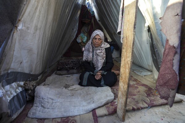 Nadia Hamouda was displaced from her home by the war between Israel and Hamas and has been living with her family in a tent in Deir al Balah, Gaza Strip, Thursday, June 13, 2024. Her daughter was killed in the war. (AP Photo/Abdel Kareem Hana)