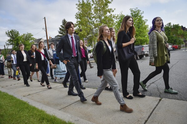 FILE - Young plaintiffs in a climate lawsuit challenging Montana's government for not doing enough to combat climate change are seen outside the Lewis and Clark County Courthouse, June 12, 2023, in Helena, Mont. The youth, who won their lawsuit saying the state was not doing enough to prevent climate change, are supporting environmental groups in their effort to block a natural gas-fired power plant on the banks of the Yellowstone River in south-central Montana. The youth filed an amicus brief in the case before the Montana Supreme Court on Tuesday, Nov. 28. (Thom Bridge/Independent Record via AP, File)