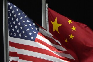 The American and Chinese flags wave at Genting Snow Park ahead of the 2022 Winter Olympics, Feb. 2, 2022, in Zhangjiakou, China. (AP Photo/Kiichiro Sato, File)