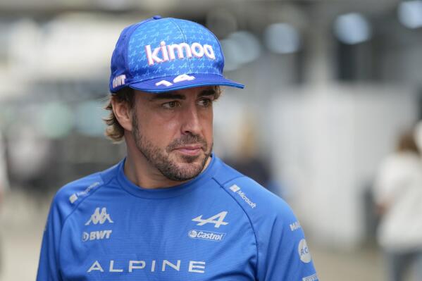 FILE - Alpine driver Fernando Alonso, of Spain, stands at the paddock ahead of Sunday's Formula One Brazilian Grand Prix, at the Interlagos racetrack in Sao Paulo, Brazil, Thursday, Nov. 10, 2022. Two-time Formula One champion Fernando Alonso says his new team Aston Martin would “not be happy with second” as it tries to build toward a title challenge in future years. (AP Photo/Andre Penner, File)