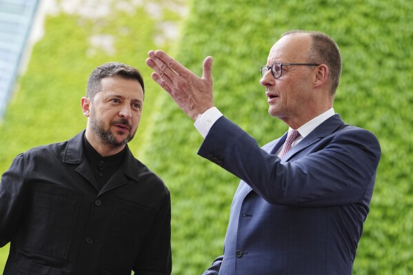 German Chancellor Friedrich Merz, right, welcomes Ukrainian President Volodymyr Zelenskyy for a meeting in Berlin, Germany, Wednesday, May 28, 2025. (Kay Nietfeld/dpa via AP)
