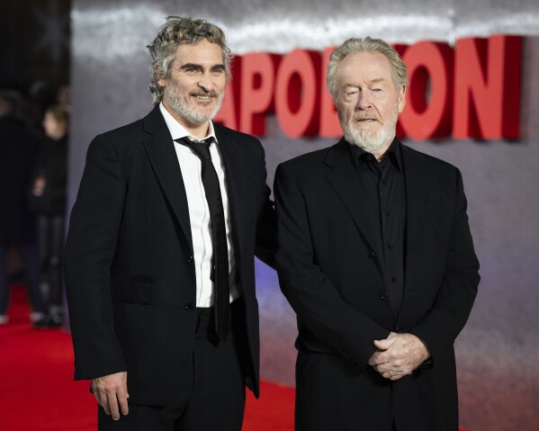 FILE - Actor Joaquin Phoenix, left, and filmmaker Ridley Scott pose for photographers upon arrival at the UK premiere of the film 
