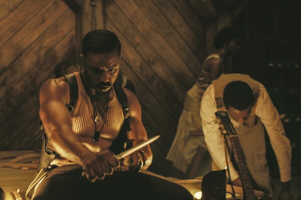 This image released by Warner Bros Pictures shows Michael B. Jordan in a scene from "Sinners." (Warner Bros. Pictures via AP)