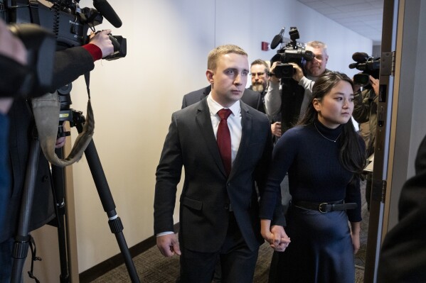 Trooper Ryan Londregan walks hand-in-hand with his wife to his first court appearance to answer to murder and manslaughter charges in the killing of Ricky Cobb II during a traffic stop last summer on Monday, Jan. 29, 2024 at the Hennepin Public Safety Facility in Minneapolis, Minn. (Renée Jones Schneider/Star Tribune via AP)