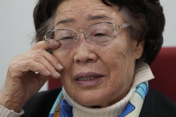 Lee Yong-soo, a South Korean sexual slavery survivor who has been demanding since the early 1990s that the Japanese government fully accept culpability and offer an unequivocal apology, wipes her tear during an interview in Seoul, South Korea, Wednesday, March 16, 2022. (AP Photo/Lee Jin-man)