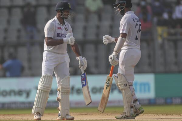 India's Cheteshwar Pujara , right, along with Mayank Agarwal looks on during the day three of their second test cricket match with New Zealand in Mumbai, India, Sunday, Dec. 5, 2021.(AP Photo/Rafiq Maqbool)