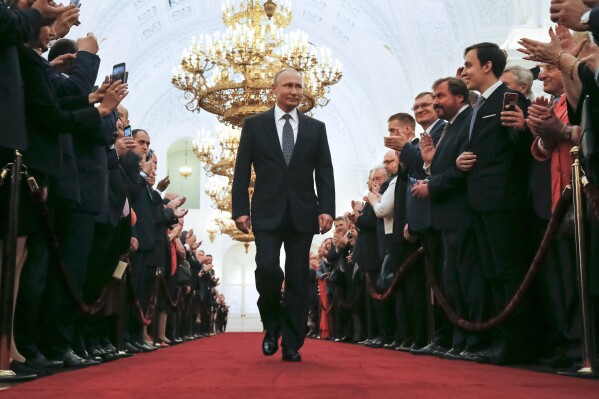 FILE - In this Monday, May 7, 2018 file photo, Vladimir Putin enters to take the oath during his inauguration ceremony as Russia's new president in the Grand Kremlin Palace in Moscow, Russia. With most opposition figures either in jail or abroad and many independent media outlets blocked, the Kremlin maintains a tight control over the country's political system and the vote is all but guaranteed to see President Vladimir Putin, 71, cement his place in power until at least 2030. (AP Photo/Alexander Zemlianichenko, Pool, File)