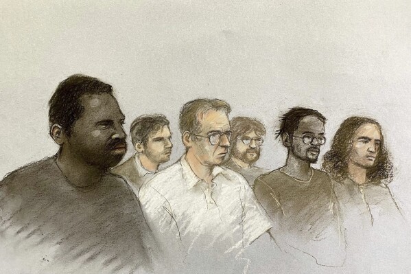This court artist drawing of front row, left to right, Nii Mensah, 23, Paul English, 61, Jakeem Rose, 23, and Ugnius Asmena, 20, and back left, Dmirjus Paulauskas, 23, and Ashton Evans, 20, back right, appearing at the Old Bailey, central London in connection with an alleged arson plot, Wednesday June 4, 2025. (PA via AP)