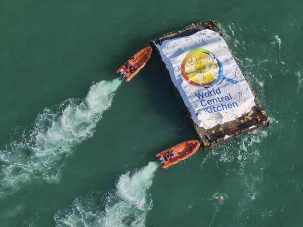 In this photo provided by the Israeli Army, humanitarian aid transported from a ship from the World Central Kitchen (WCK) organization, led by the United Arab Emirates, arrives in the Gaza Strip’s maritime space, Friday, March 15, 2024. The Israeli military says a ship has delivered 200 tons of food, water and humanitarian supplies to Gaza, inaugurating a sea route from Cyprus. The sea route is intended to bring more assistance to alleviate the humanitarian crisis in the enclave five months into the war between Israel and Hamas. (Israeli Army via AP)