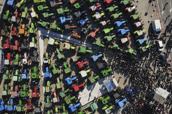 Protesting farmers with their tractors take part in a rally outside an agricultural fair in the port city of Thessaloniki, northern Greece, Thursday, Feb. 1, 2024. Greek farmers – hit by rising costs and crop damage caused by recent floods and wildfires – are threatening to block highways to press demands for tax relief and higher subsidy payments. (AP Photo/Giannis Papanikos)