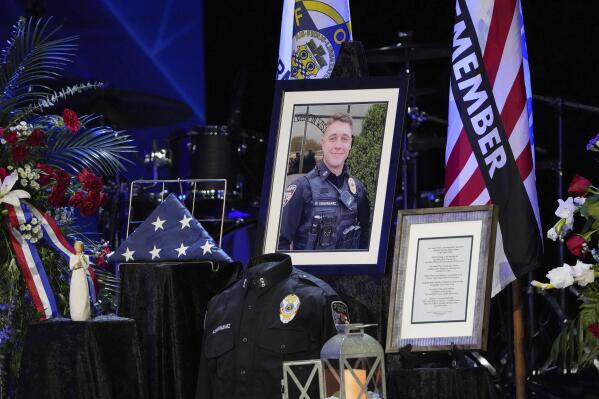 Pictures and mementos are displayed at the funeral for 24-year-old Elwood Police Officer Noah Shahnavaz at ITOWN Church, on Saturday, Aug. 6, 2022, in Fishers, Ind. Shahnavaz was fatally shot while making a traffic stop in Madison County on July 31. (Jenna Watson/The Indianapolis Star via AP)