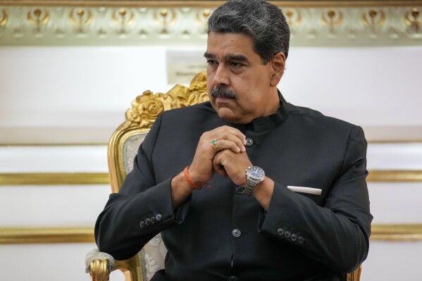 FILE - Venezuelan President Nicolás Maduro listens during their meeting at Miraflores presidential palace in Caracas, Venezuela, Feb. 20, 2024. On Thursday, Feb. 22, Joshua Holt, a Utah man imprisoned for nearly two years in Venezuela, sued Maduro, accusing the leftist leader of heading a “criminal enterprise” that kidnaps, tortures and unjustly imprisons American citizens. (AP Photo/Ariana Cubillos, File)