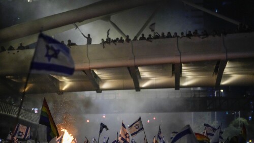 Bonfires burn as Israelis occupy the Ayalon Highway to protest against plans by Prime Minister Benjamin Netanyahu's government to overhaul the judicial system, in Tel Aviv, Thursday, July 20, 2023. (AP Photo/Ariel Schalit)