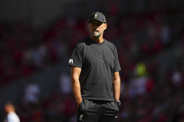 Liverpool's manager Jurgen Klopp watches his players warm up before the English Premier League soccer match between Liverpool and Aston Villa at Anfield stadium in Liverpool, Sunday, Sept 3, 2023. (AP Photo/Jon Super)