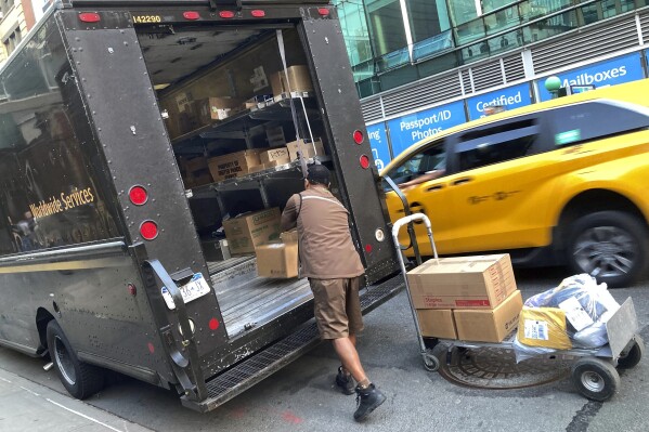 FILE - A United Parcel Service driver loads his truck, adjacent to a UPS Store, in New York, Thursday, May 11, 2023. Frustrated by what he called an "appalling counterproposal" earlier this week, the head of the union representing 340,000 UPS workers said a strike now appears inevitable and gave the shipping giant a Friday deadline to improve its offer. (AP Photo/Richard Drew, File)