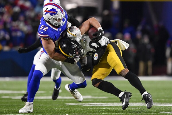 Buffalo Bills linebacker A.J. Klein (52) tackles Pittsburgh Steelers running back Jaylen Warren (30) during the fourth quarter of an NFL wild-card playoff football game, Monday, Jan. 15, 2024, in Buffalo, N.Y. (AP Photo/Adrian Kraus)