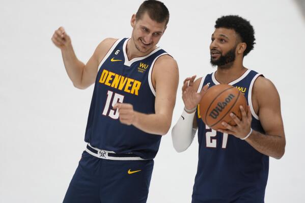 Denver Nuggets center Nikola Jokic, left, jokes around with guard Jamal Murray during the NBA basketball team's Media Day, Monday, Sept. 26, 2022, in Denver. (AP Photo/David Zalubowski)