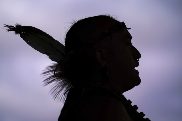 FILE - Tatanka Gibson of the Haliwa-Saponi/Nansemond Tribal Nations leads attendees in song and dance during a gathering marking Indigenous Peoples Day at Penn Treaty Park, Oct. 11, 2021, in Philadelphia. Native American people will celebrate their centuries-long history of resilience on Monday, Oct. 9, 2023, through ceremonies, dances and speeches. The events across the United States will come two years after President Joe Biden officially commemorated Indigenous Peoples Day. (AP Photo/Matt Rourke, File)