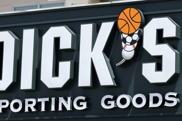 FILE -This photo taken Tuesday, Aug. 29, 2017, shows a Dick's Sporting Goods sign at a store in Miami. (AP Photo/Alan Diaz, File)