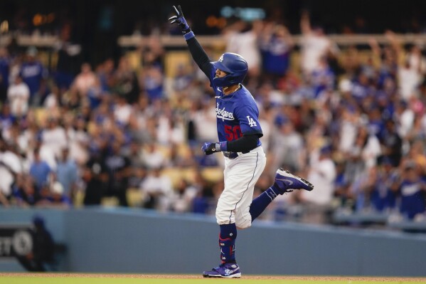 Los Angeles Dodgers' Mookie Betts celebrates while running the bases on a home run against the Miami Marlins during the fifth inning of the second baseball game of a doubleheader Saturday, Aug. 19, 2023, in Los Angeles. (AP Photo/Ryan Sun)