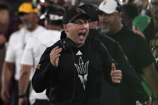 Arizona State head coach Kenny Dillingham celebrates a touchdown against Kansas during the second half of an NCAA college football game Saturday, Oct. 5, 2024, in Tempe, Ariz. (AP Photo/Darryl Webb, File)