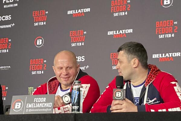 Fedor Emelianenko, left, laughs at a comment by interpreter Georgiy Litvinov during a news conference in Los Angeles on Wednesday, Feb. 1, 2023. Emelianenko says he is retiring from his memorable mixed martial arts career after he fights Ryan Bader for the Bellator heavyweight title on Saturday, Feb. 4. (AP Photo/Greg Beacham)