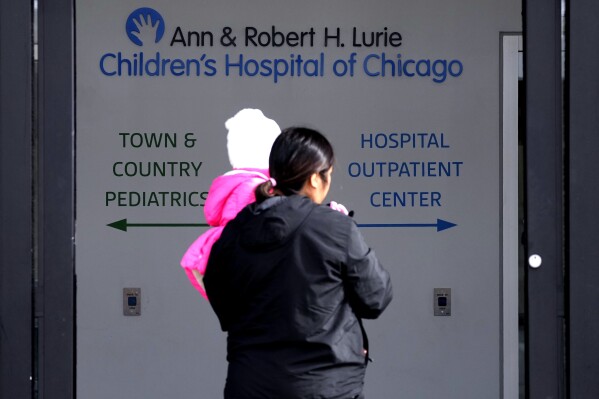 FILE - Lurie Children's Hospital sign is seen at the hospital as patients walk in, Feb. 5, 2024, in Skokie, Ill. A cyberattack on a renowned children’s hospital in Chicago has left some parents scrambling. They've had to reschedule surgeries on babies or scramble to get prescriptions filled for their sick kids. Experts warn this is just the start of a growing trend of foreign criminals attacking U.S. hospitals for hefty ransoms. (AP Photo/Nam Y. Huh, File)