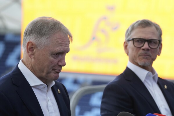 Australia's national rugby union head coach Joe Schmidt, left, speaks in Sydney as future head coach Les Kiss listens on April 30, 2025. (AP Photo/Rick Rycroft)