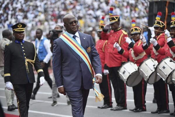 Congo's President Felix Tshisekedi reviews a honor guard during his swearing in ceremony for a second term in Kinshasa, Democratic Republic of the Congo, Saturday, Jan. 20, 2024. Tshisekedi promised a huge crowd of supporters and several heads of state to unite the Central African country during his second five-year term and to protect lives in the conflict-hit eastern region. (AP Photo/Guylain Kipoke )