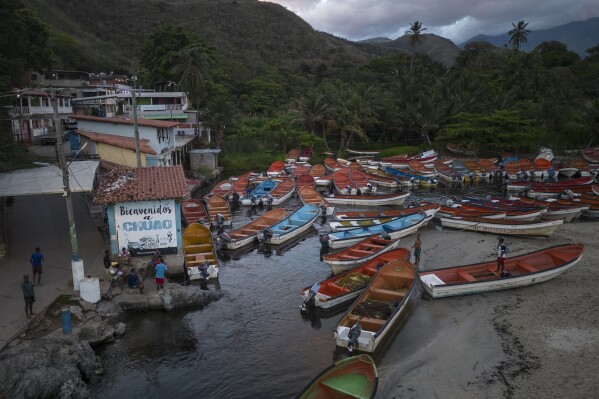 Fishing boats are anchored on a river in Chuao, Venezuela, Wednesday, early June 7, 2023. Long before sunrise, dozens of people gather around more than 50 boats along this portion of Venezuela’s vast Caribbean coast, most of them being men, but women are increasingly among them. (AP Photo/Matias Delacroix)