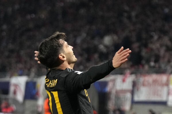 Real Madrid's Brahim Diaz celebrates after he scored the opening goal during the Champions League round of 16 first leg soccer match between RB Leipzig and Real Madrid at the Red Bull arena stadium in Leipzig, Germany, Tuesday, Feb. 13, 2024. (AP Photo/Matthias Schrader)