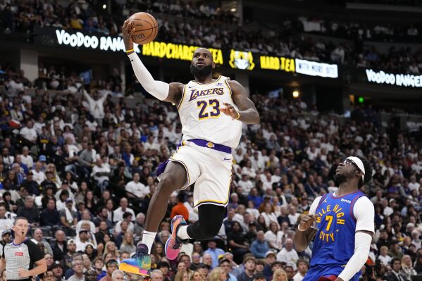 Los Angeles Lakers forward LeBron James (23) goes up to shoot against Denver Nuggets guard Reggie Jackson (7) during the first half in Game 1 of an NBA basketball first-round playoff series Saturday, April 20, 2024, in Denver. (AP Photo/Jack Dempsey)