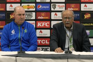 Head of Pakistan Cricket Board's Managing Committee Najam Sethi, right, speaks as newly appointed Pakistan cricket team's director Mickey Arthur looks on during a press conference, in Rawalpindi, Pakistan, Thursday, April 20, 2023. Arthur has been appointed as Pakistan cricket team's director and will be part of national team's coaching staff for this year's World Cup. (AP Photo/Anjum Naveed)