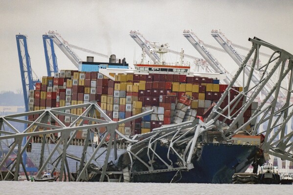 FILE - The container ship Dali, owned by Grace Ocean PTE, rests against wreckage of the Francis Scott Key Bridge in the Patapsco River, March 27, 2024, as seen from Pasadena, Md. The White House is seeking roughly $4 billion in additional emergency funding from Congress for costs related to the collapse and repair of the Francis Scott Key bridge in Baltimore and to respond to other disasters that have occurred around the U.S. in recent months. That money is part of a new emergency request from President Joe Biden's administration that essentially re-ups a broader, $56 billion ask from last October that Congress virtually ignored. (ĢӰԺ Photo/Alex Brandon, File)