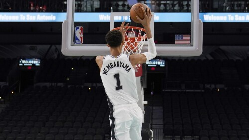 San Antonio Spurs' Victor Wembanyama, the No. 1 draft pick, shoots during an NBA basketball press conference, Saturday, June 24, 2023, at the AT&T Center in San Antonio. (AP Photo/Eric Gay)