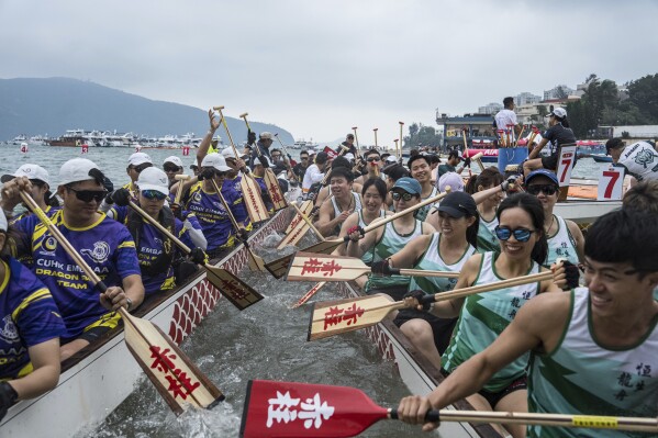 Competitors cheer and celebrate after the race in the Stanley International Dragon Boat Championships to celebrate the Dragon Boat Festival in Hong Kong, Saturday, May 31, 2025. (AP Photo/Chan Long Hei)