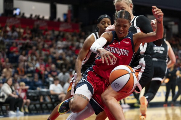 Washington Mystics guard Natasha Cloud, front, loses control of the ball during the second quarter of a WNBA basketball game against the Phoenix Mercury, Sunday, July 23, 2023, in Washington. (AP Photo/Stephanie Scarbrough)