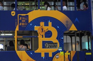 FILE - An advertisement for the cryptocurrency Bitcoin displayed on a tram, May 12, 2021, in Hong Kong. Now that bitcoin funds are trading, which is the best to own? The answer is not necessarily the one that rises the most. (AP Photo/Kin Cheung, File)