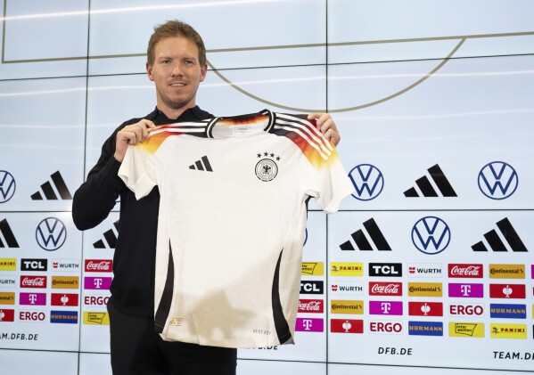 Germany coach Julian Nagelsmann presents the DFB team's new official European Championship jersey ahead of the international friendly matches against France and The Netherlands, during a press conference in Frankfurt, Germany, Thursday, March 14, 2024. (Boris Roessler/dpa via AP)