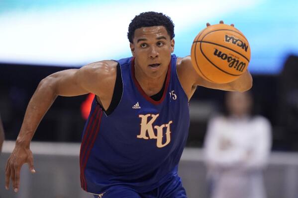 Kansas guard Kevin McCullar Jr. drives during Late Night in the Phog, the school's annual NCAA college basketball kickoff, at Allen Fieldhouse, Friday, Oct. 14, 2022, in Lawrence, Kan. (AP Photo/Charlie Riedel)