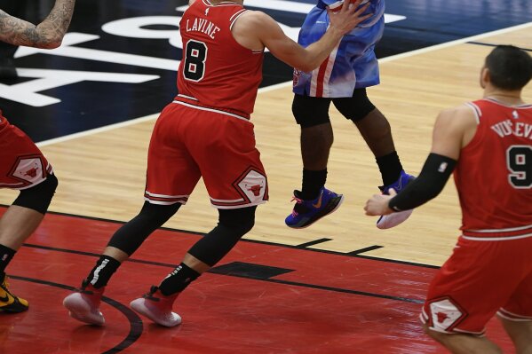 Brooklyn Nets' Kyrie Irving (11) goes up for a shot against Chicago Bulls' Zach Lavine (8) during the first half of an NBA basketball game Sunday, April 4, 2021, in Chicago. (AP Photo/Paul Beaty)
