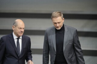 FILE - German Chancellor Olaf Scholz, left, and German Finance Minister Christian Lindner arrive for the debate about the budget 2023 at the parliament Bundestag in Berlin, Germany, on Nov. 22, 2022. Germany's economy shrank in recent months and business confidence is still in the dumps, according to figures released Friday, Nov. 24, 2023 while the government is struggling to overcome a budget crisis that threatens to exacerbate problems in what was already the world’s worst-performing major developed economy. (AP Photo/Markus Schreiber, File)