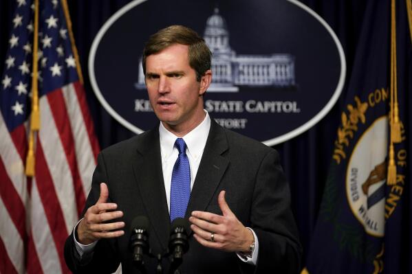 FILE - Kentucky Democratic Gov. Andy Beshear speaks to the press at the Capitol in Frankfort, Ky., on Wednesday, Feb. 19, 2020. Gov. Beshear said Thursday, July 14, 2022, there's “enough credit to go around” for Kentucky's record-setting budget surpluses during his tenure, as he delved into economic issues amid Republican attacks over surging nationwide inflation that's squeezing household budgets. (AP Photo/Bryan Woolston, File)