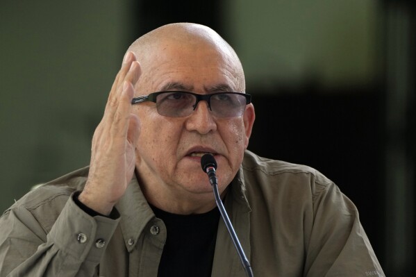 FILE - Antonio Garcia, of the Colombian guerrilla National Liberation Army (ELN), speaks to the press after signing an agreement with the Colombian government to resume peace talks, in Caracas, Venezuela, on Oct. 4, 2022. Garcia said on Monday Dec. 25, 2023 it would only abide by a recent agreement to suspend the kidnappings of civilians for ransom if the government keeps its promise to finance projects that could provide the rebels with alternate sources of income. (AP Photo/Ariana Cubillos, File)